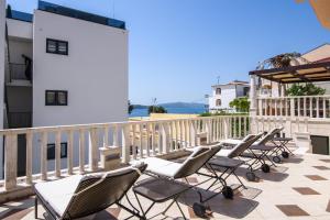 a row of chairs sitting on a balcony at Villa Lavandula with heated swimming pool in Trogir