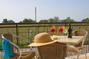 a table with a straw hat sitting on a patio at The Lighthouse Rooms in Lazise