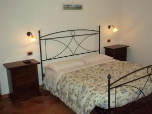 a bedroom with a bed and two night stands and lights at B&B Il Girasole in Montepulciano