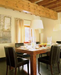 a dining room with a wooden table and chairs at Casa Granero in Rascafría
