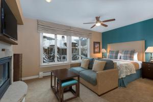 a bedroom with a bed and a couch and a window at The Residences at Mountain Lodge by Hyatt Vacation Club in Beaver Creek