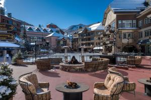 a patio with chairs and a fire pit in a resort at The Residences at Mountain Lodge by Hyatt Vacation Club in Beaver Creek