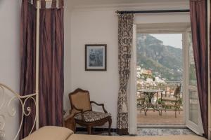 a living room with a door open to a balcony at Hotel Posa Posa in Positano