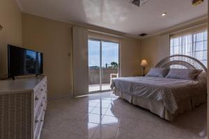 a bedroom with a bed and a flat screen tv at King David Suites in Palm-Eagle Beach +48 photos