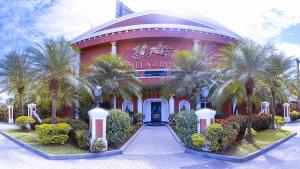 a large building with palm trees in front of it at Motel Villa di Roma (Adults Only) in Guarujá