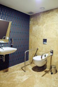 a bathroom with a bath tub and a sink at Demora Hotel in Ankara