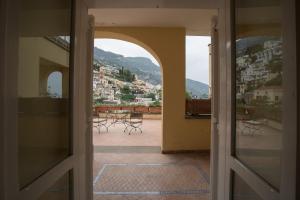 an open door with chairs and a view of a city at Hotel Posa Posa in Positano