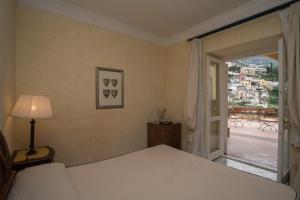 a bedroom with a bed and an open door at Hotel Posa Posa in Positano +34 photos