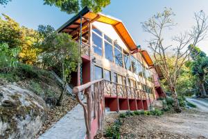 a house on the side of a mountain at Sueños del Bosque Lodge in San Gerardo de Dota