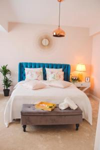 a bedroom with a large bed with a blue headboard at Bucharest Victoria Apartment in Bucharest