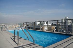 a swimming pool on the roof of a building at Austral Rentahome Santa Beatriz in Santiago