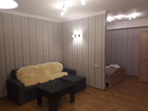 a living room with a couch and a table at Busas Apartment in Tbilisi City