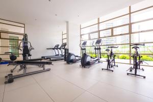 a gym with treadmills and elliptical machines at Kennedy Dream Apartment in Santiago