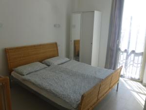 מיטה או מיטות בחדר ב-Appartamento FIORE