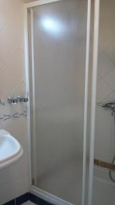コインブラにあるResidencial Moedaのバスルーム(ガラスドア付きのシャワー付)