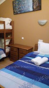 a bedroom with a blue bed with towels on it at Residencial Moeda in Coimbra