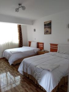 Postel nebo postele na pokoji v ubytování Libertad Hotel