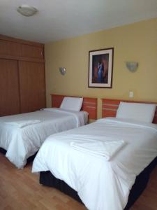 Postel nebo postele na pokoji v ubytování Libertad Hotel