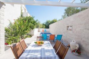 a table with a bowl of fruit on a patio at Apartments Petranic in Supetar