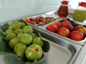 a refrigerator with a tray of apples and other fruits at B&B Fellini Gallipoli in Gallipoli