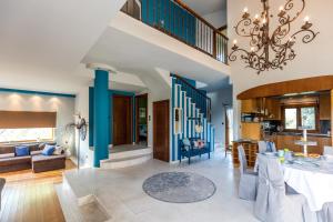 a living room with blue walls and a chandelier at Fokas Luxury Villa in Prinos