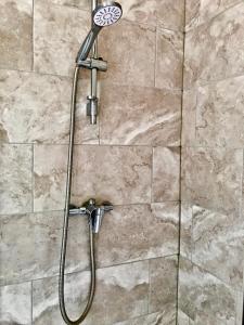 a shower with a shower head in a bathroom at Perry Road, beautiful large house available for Guests and Contractors Parking wifi in Nottingham