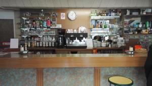 a counter in a coffee shop with a coffee machine at Hotel La Reserve in Vic-la-Gardiole