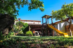 a playground with a slide in a yard at Country House Paola in Marina di Gioiosa Ionica