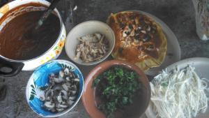 a table topped with bowls of different types of food at Teocalli in Teotitlán del Valle