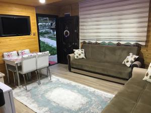 a living room with a couch and a table at New toprak suite in Uzungöl