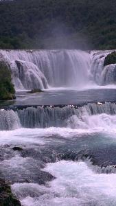 a large waterfall in the middle of a river at Apartment Abia in Bihać