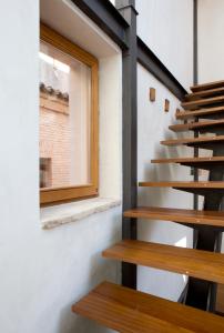 a staircase in a house with a window at Antidoto Rooms San Agustín - Recomendado para adultos in Toledo