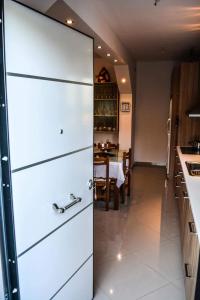 a white refrigerator in a kitchen with a table at Sofia's sea view house in Vravrona
