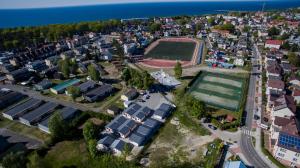 an aerial view of a city with a soccer field at Domki Aleja Róż in Międzyzdroje