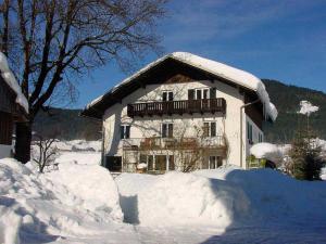 a snow covered house with a balcony on top of it at Ferienwohnung Laserer in Gosau