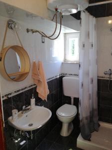 a bathroom with a sink and a toilet and a mirror at Apartman Sara in Pula +38 photos