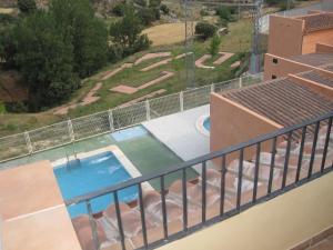 a view from the balcony of a house with a swimming pool at Alojamientos rurales Angelita in Olocau del Rey