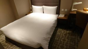 Katil atau katil-katil dalam bilik di Orange Hotel - Wenhua, Chiayi