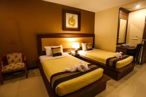 Postel nebo postele na pokoji v ubytování Madina Rayong Hotel