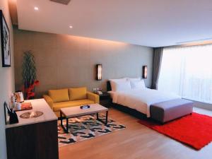 a hotel room with a bed and a couch at Shui Nong motel in Chiayi City