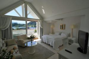 a bedroom with a bed and a large window at Sunde Fjord Hotel, free and easy parking in Solavagen