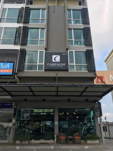a building with a sign on the front of it at Campagne Hotel and Residence - SHA Plus in Pathum Thani
