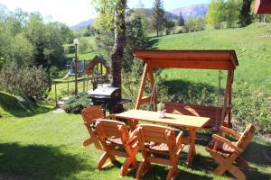 a table and chairs with a gazebo and a playground at Romantické ubytovanie Holiday House Daniela & Štúdio Júlia in Ždiar