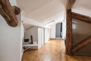- un couloir mansardé avec une porte en bois et du parquet dans l'établissement Sete, à Sète