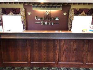 
a counter with a sign for a barber shop at Countryside Suites Omaha in Omaha
