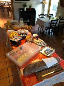a table with a buffet of food on it at Auberge de la Réunion in Coinsins