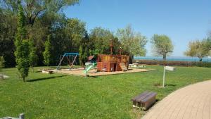 a park with a playground with a swing at Surman Apartmanok in Siófok