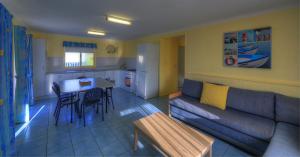 a living room with a couch and a table at Beachcomber Holiday Park in Potato Point