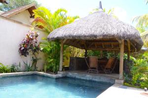 a hut with chairs and a swimming pool at Villa Dodo in Pereybere