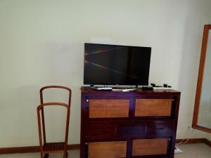 a flat screen tv sitting on top of a wooden dresser at Villa Dodo in Pereybere